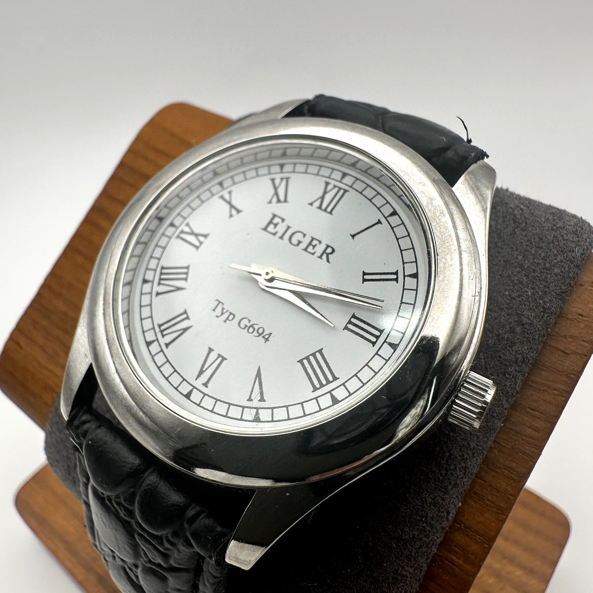 Eiger Typ G694 Silver Tone Quartz Watch White Dial Roman Numerals Black Embossed Strap