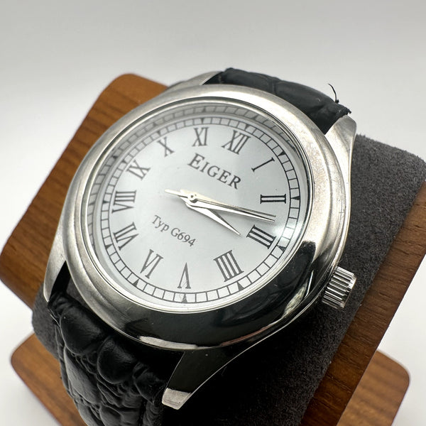 Eiger Typ G694 Silver Tone Quartz Watch White Dial Roman Numerals Black Embossed Strap