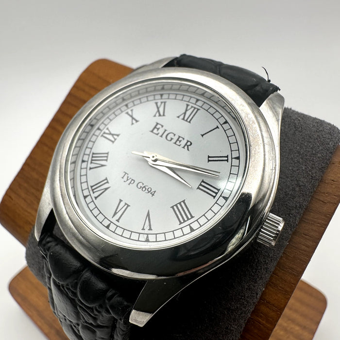 Eiger Typ G694 Silver Tone Quartz Watch White Dial Roman Numerals Black Embossed Strap