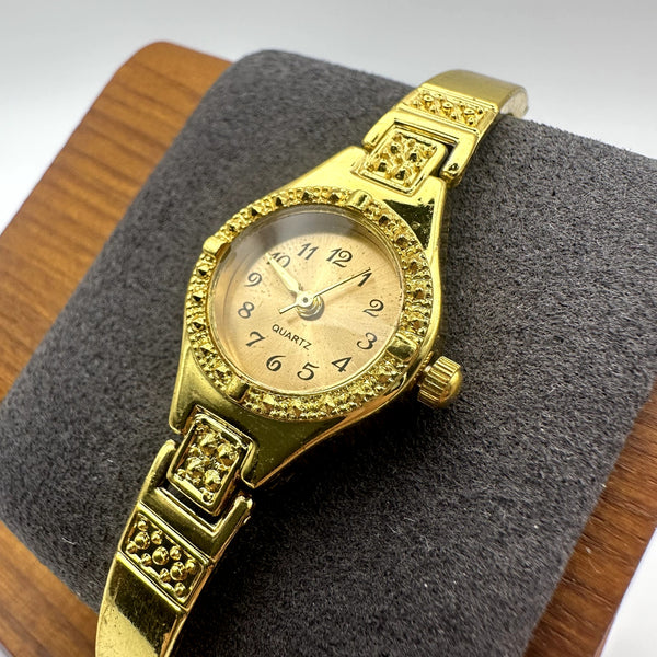 Vintage Gold Tone Quartz Bracelet Watch with Textured Bezel, Oval Dial