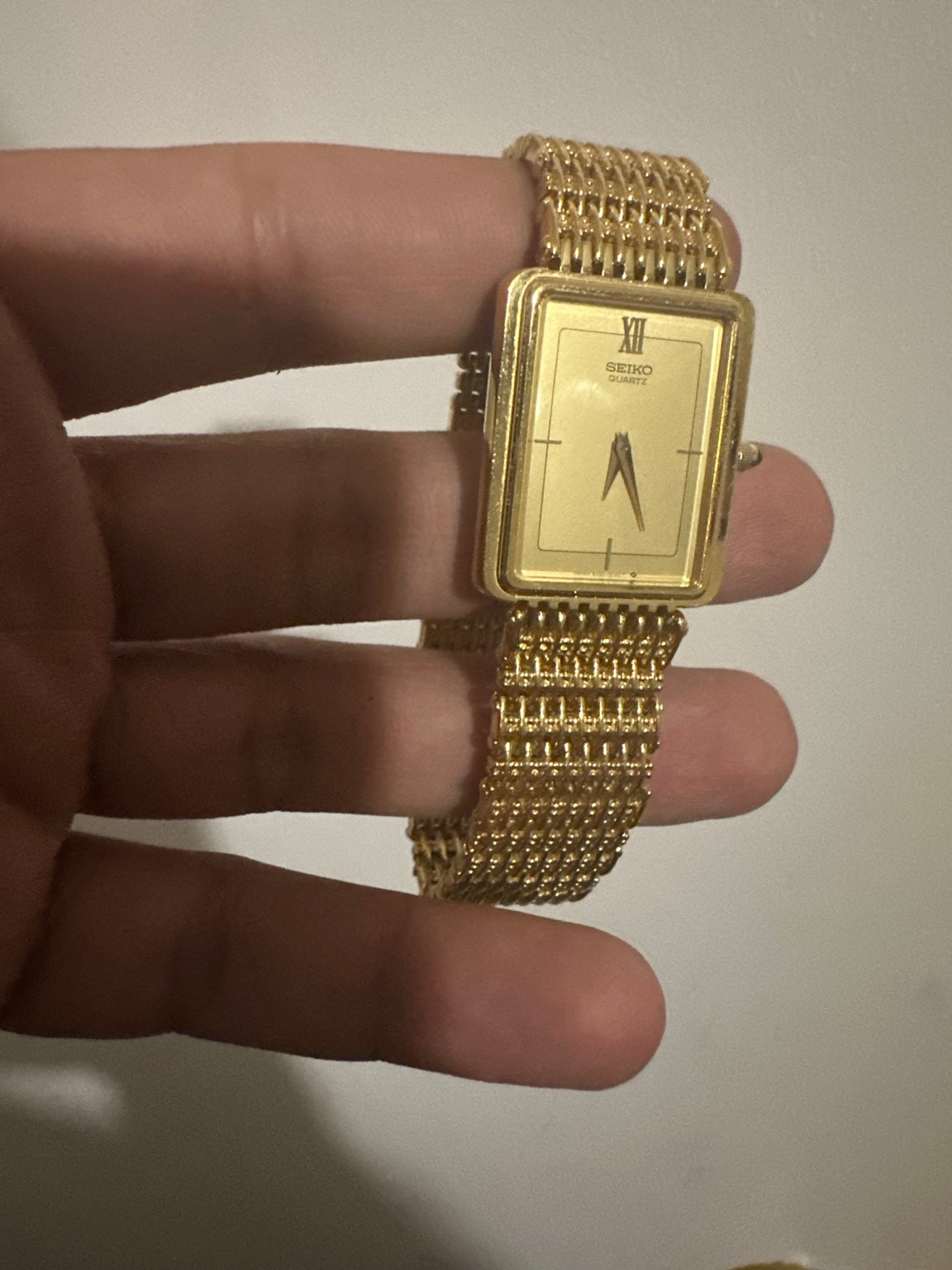 Jay holding a vintage gold-tone Seiko watch